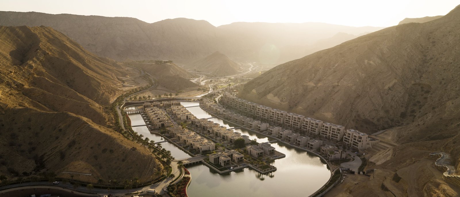 Muscat Bay coastal community between mountains and sea